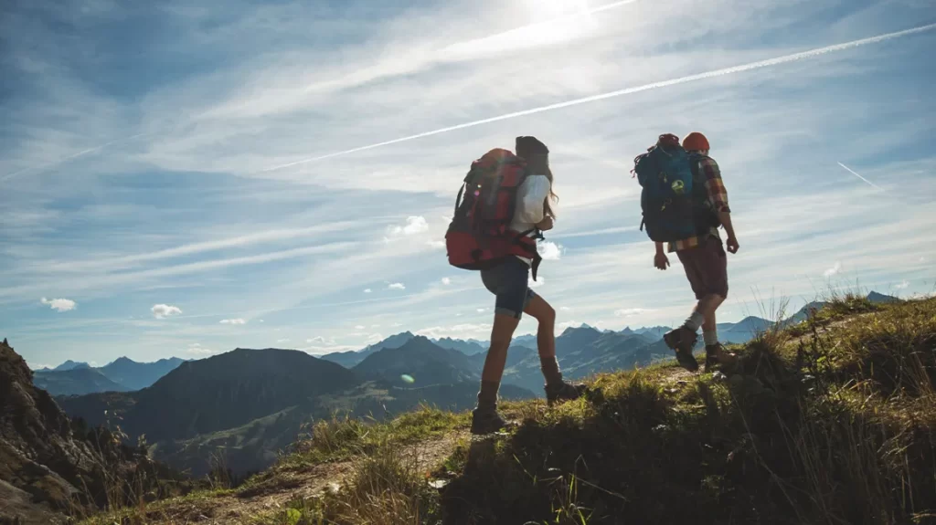 What muscles does hiking work? You may wish to conquer the trails! couple hiking mountain climbing 1296x728 header