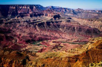 Panoramic view of the Grand Canyon with layered rock formations and Colorado River